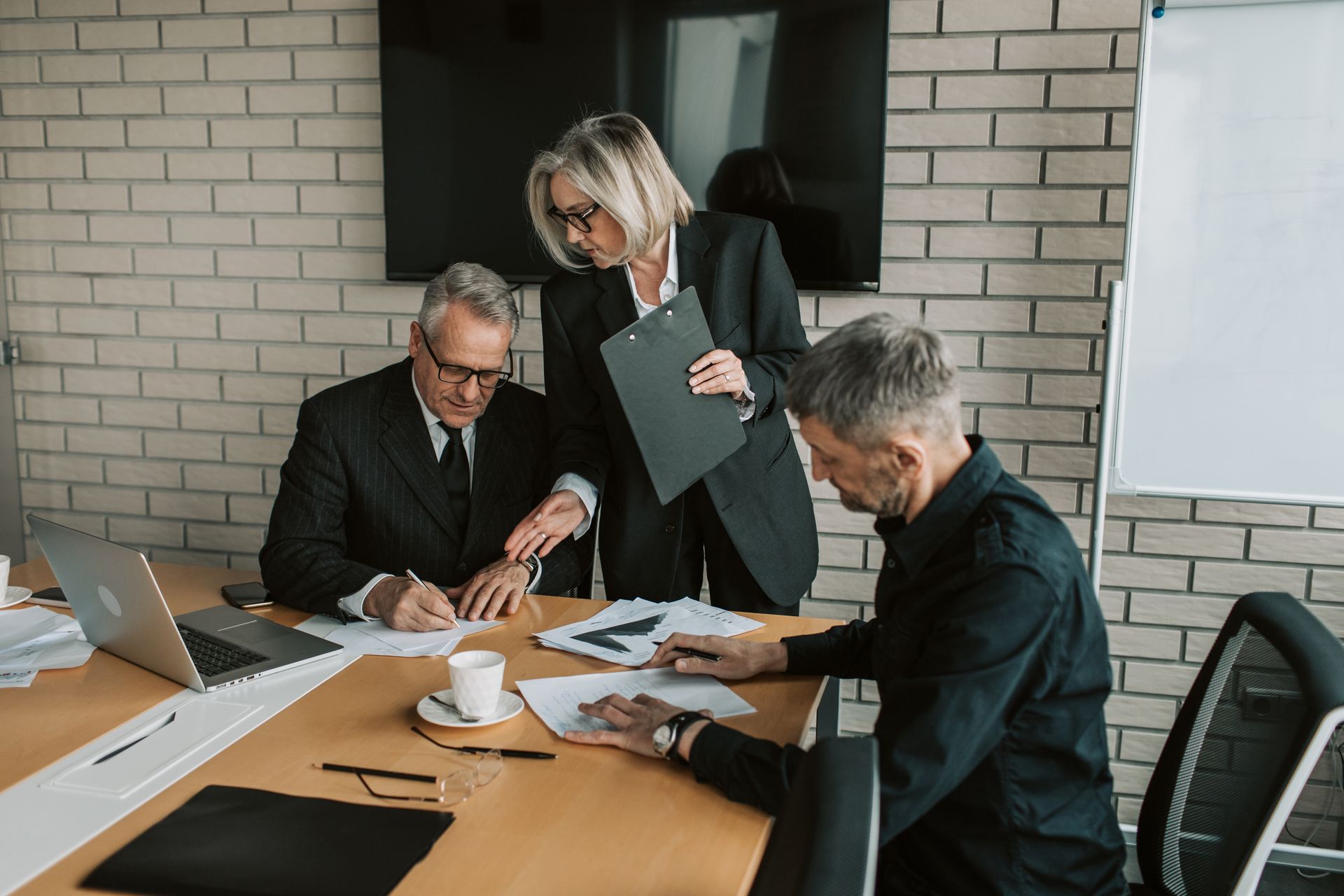Business partners working through documents together at a table